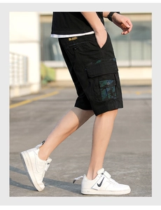 Detail of cargo shorts showing side pockets with camo patterns and durable cotton fabric