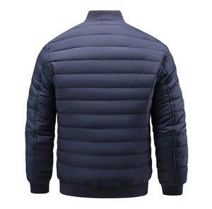 Rear view of navy quilted bomber jacket featuring ribbed collar and hem detail