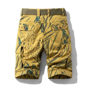 Men's mustard yellow multi-pocket cargo shorts with tropical jungle leaf print pattern