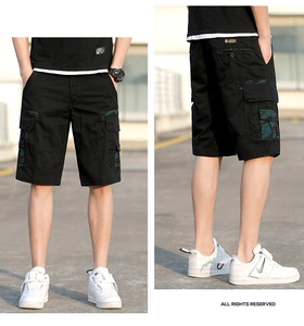 Detail of cargo shorts featuring multi-pockets with camo patches and durable cotton fabric