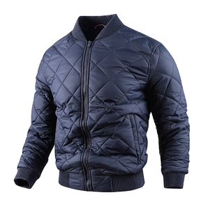 Detail of navy quilted bomber jacket featuring diamond stitching and ribbed cuffs