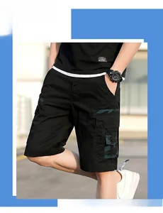 Detail view of mens cargo shorts with black cotton twill and camo utility pockets