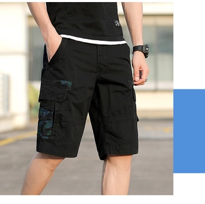 Detail of black cargo shorts with camouflage pocket flaps and heavy-duty cotton fabric
