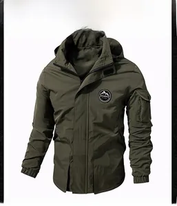 Detail of army green hooded jacket showing mountain badge and utility sleeve pocket