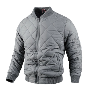 Detailed close-up of grey diamond-quilted bomber jacket with ribbed collar and zipper