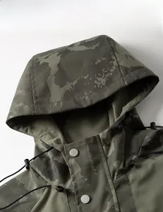 Detail of camouflage hooded jacket showing metal snap buttons and adjustable drawstrings