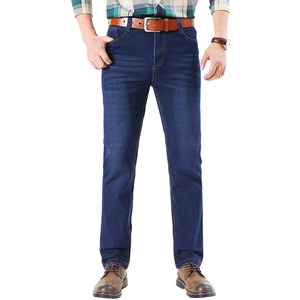 Men's straight leg dark blue denim jeans with washed cat whiskers and casual brown belt