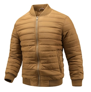 Detailed close-up of quilted camel bomber jacket with ribbed cuffs and metallic zipper
