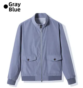 Detail of grey-blue work jacket featuring stand collar with buttons and metal zipper
