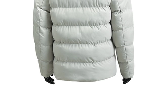 Detail view of light grey winter jacket showing thick horizontal quilting and warm fabric
