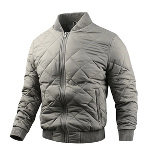 Detailed view of grey quilted bomber jacket with classic diamond stitching and ribbed collar