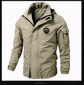 Detail of khaki tactical hooded jacket featuring chest mountain logo and sleeve pocket