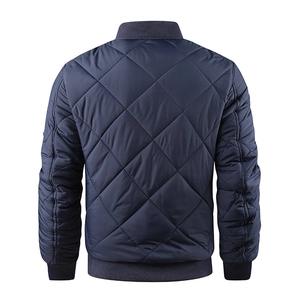 Detailed back view of navy blue quilted bomber jacket with classic diamond pattern and ribbed hem