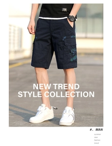 Close-up of navy cargo shorts featuring camo patterned side pockets and premium stitching