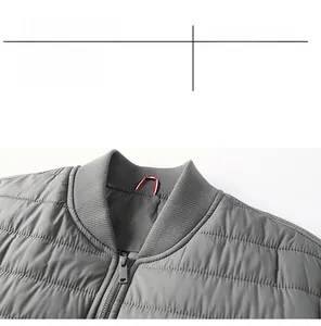 Macro detail of men's grey quilted bomber jacket showing ribbed collar and zipper quality