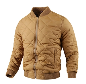 Detail of khaki brown quilted jacket featuring classic diamond stitching and ribbed cuffs