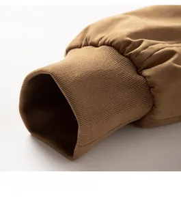 Detail shot of brown worker jacket featuring ribbed cuffs and precise stitching details