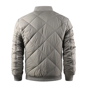 Detail view of light grey quilted jacket featuring diamond stitching and ribbed trim details