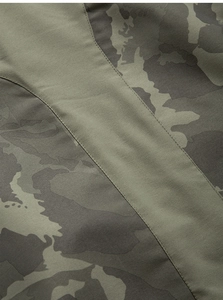 Close-up of double-stitched seams and camouflage fabric on outdoor jacket