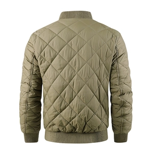 Macro shot of the khaki quilted diamond stitching and ribbed knit cuffs on the jacket