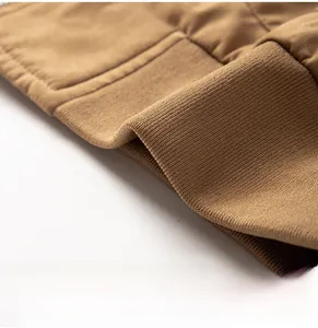 Close-up of ribbed knit hem and neat stitching on a khaki casual workwear jacket