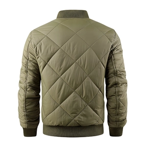 Detail view of olive green quilted bomber jacket featuring diamond stitching and ribbed hem