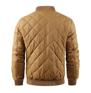 Detail of men's mustard yellow quilted jacket featuring stand collar and ribbed cuffs