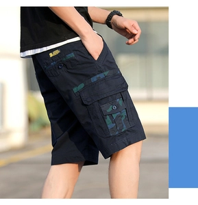 Detail of cargo shorts showing camo-patterned side pockets and durable navy twill fabric