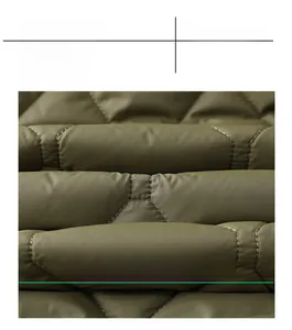 Detail of olive green quilted winter jacket fabric with premium diamond stitching texture