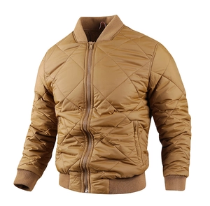 Detailed view of light brown quilted jacket with rib-knit collar and diamond stitching
