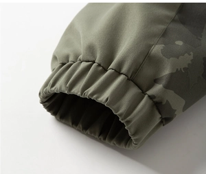 Detailed macro view of military green jacket elastic cuffs with camouflage pattern stitching