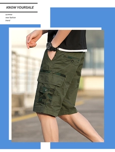 Close-up of olive cargo shorts with camouflage side pockets and durable cotton twill fabric