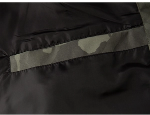 Detailed close-up of inner pocket and camouflage fabric on the men's outdoor jacket