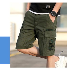 Detail view of cargo shorts pocket with camouflage trim and durable green cotton fabric