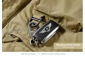 Tactical jacket details showing a durable metal D-ring and utility hook with fine stitching