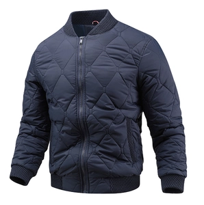 Detail of navy blue quilted bomber jacket with stand collar and ribbed cuffs