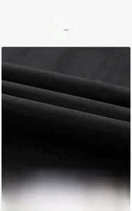 Detail of black jacket fabric showing windproof waterproof and breathable features
