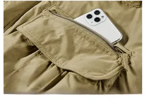 Detailed view of heavy-duty invisible zipper pocket on khaki outdoor thermal winter jacket
