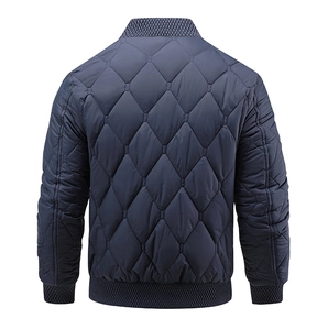Rear view of navy blue quilted bomber jacket with diamond stitching and ribbed trim