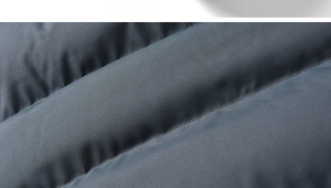 Macro shot of high-density navy blue fabric with horizontal quilting and matte finish
