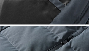 Detail of dark grey quilted jacket showing smooth zipper pocket and windproof fabric