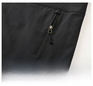 Detailed close-up of zipper pocket on black casual jacket showing ripstop fabric texture