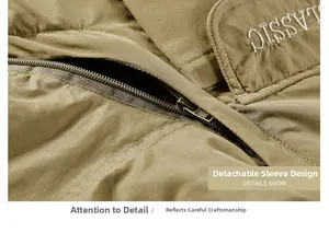 Detail of khaki outdoor jacket showing detachable sleeve craft and classic metal zipper