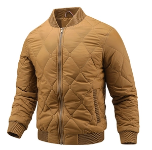 Detail of ochre diamond quilted bomber jacket featuring ribbed collar and metal zipper