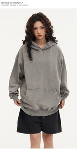 Detail of heavy cotton washed grey hoodie with dropped shoulders and kangaroo pocket
