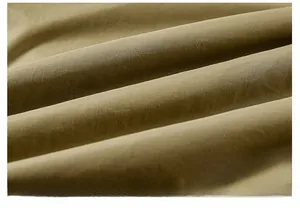 Macro shot of thick mustard green velvet fabric showing warm texture and detail