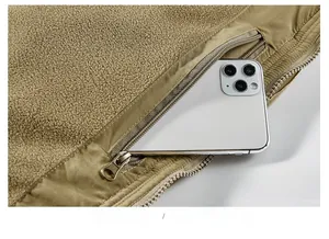 Detailed view of winter fleece jacket showing functional interior zipper safety pocket for phone