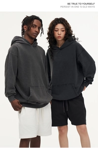 Detailed close-up of heavyweight acid wash hoodie fabric and front kangaroo pocket