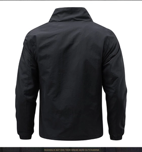 Detail view of the back of a black men's casual jacket with stand collar and tech fabric