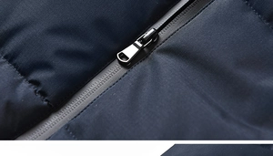Detailed macro view of the durable metal zipper and quilted windproof fabric of the jacket